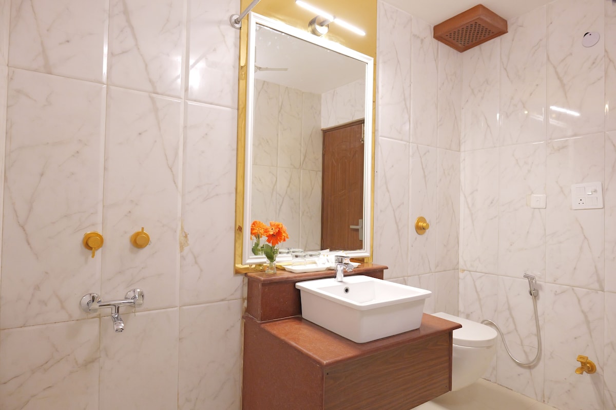 A bathroom with a white sink, mirror, and shower.