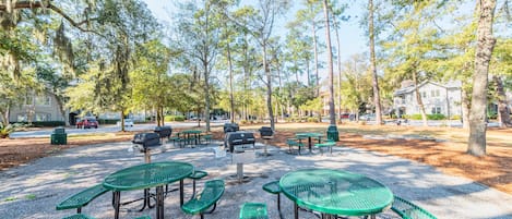 A park with picnic tables and barbecue grills.