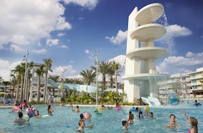 A swimming pool area with multiple water slides and palm trees. - Universal's Cabana Bay Beach Resort (Orlando)