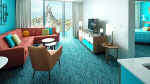 A modern hotel room with a large window, a sofa, a TV, a desk, and a bed. - Universal's Cabana Bay Beach Resort (Orlando)