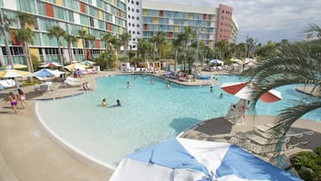 Relax by the inviting pool surrounded by sun loungers and umbrellas.
