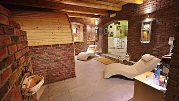 Relax in this serene spa room with a massage chair, sink, and mirror.
