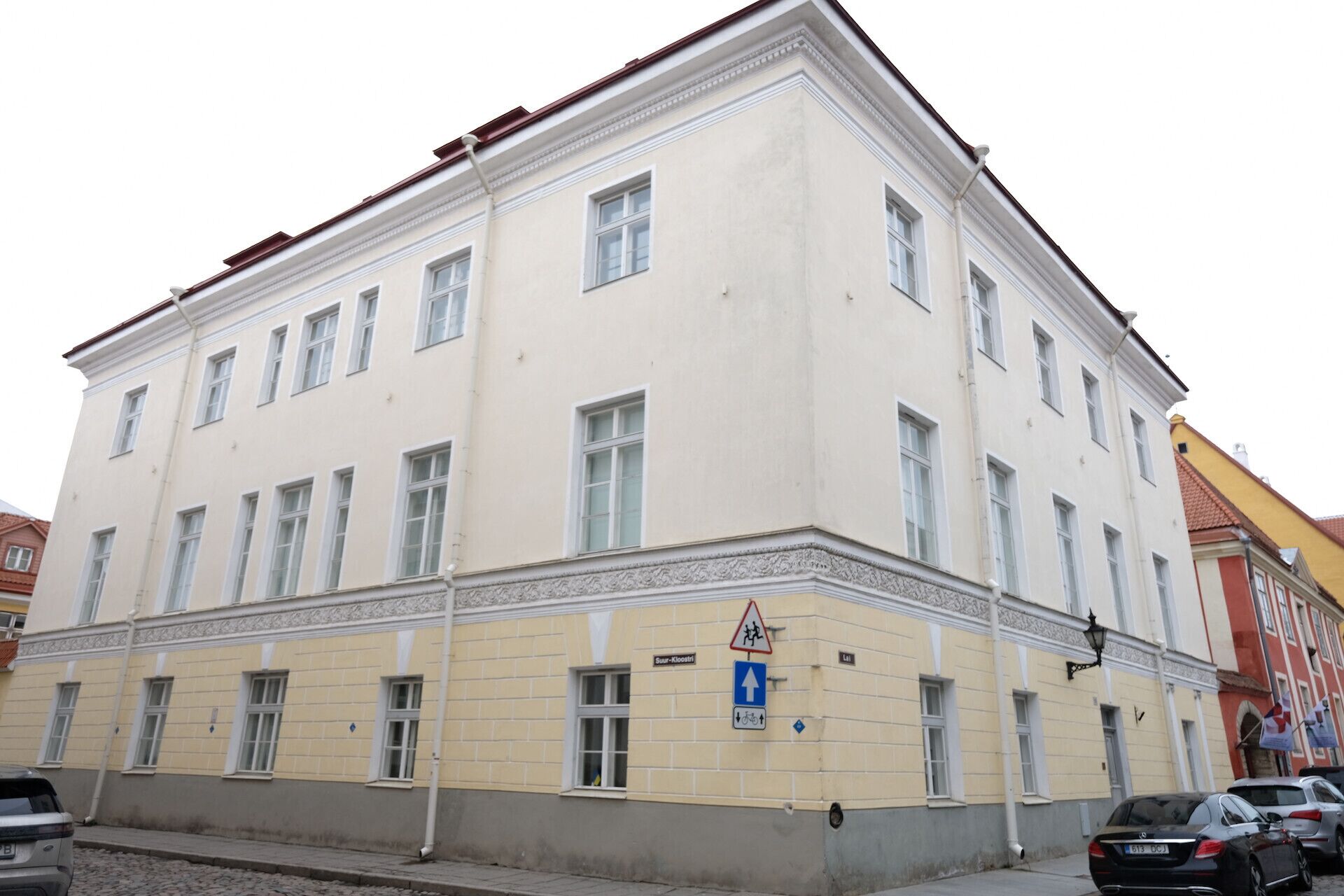 A multi-story building with a classical architectural style, featuring a symmetrical facade with evenly spaced windows and decorative moldings.