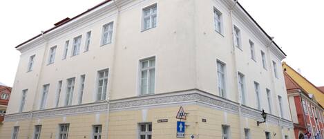 A multi-story building with a classical architectural style, featuring a symmetrical facade with evenly spaced windows and decorative moldings.