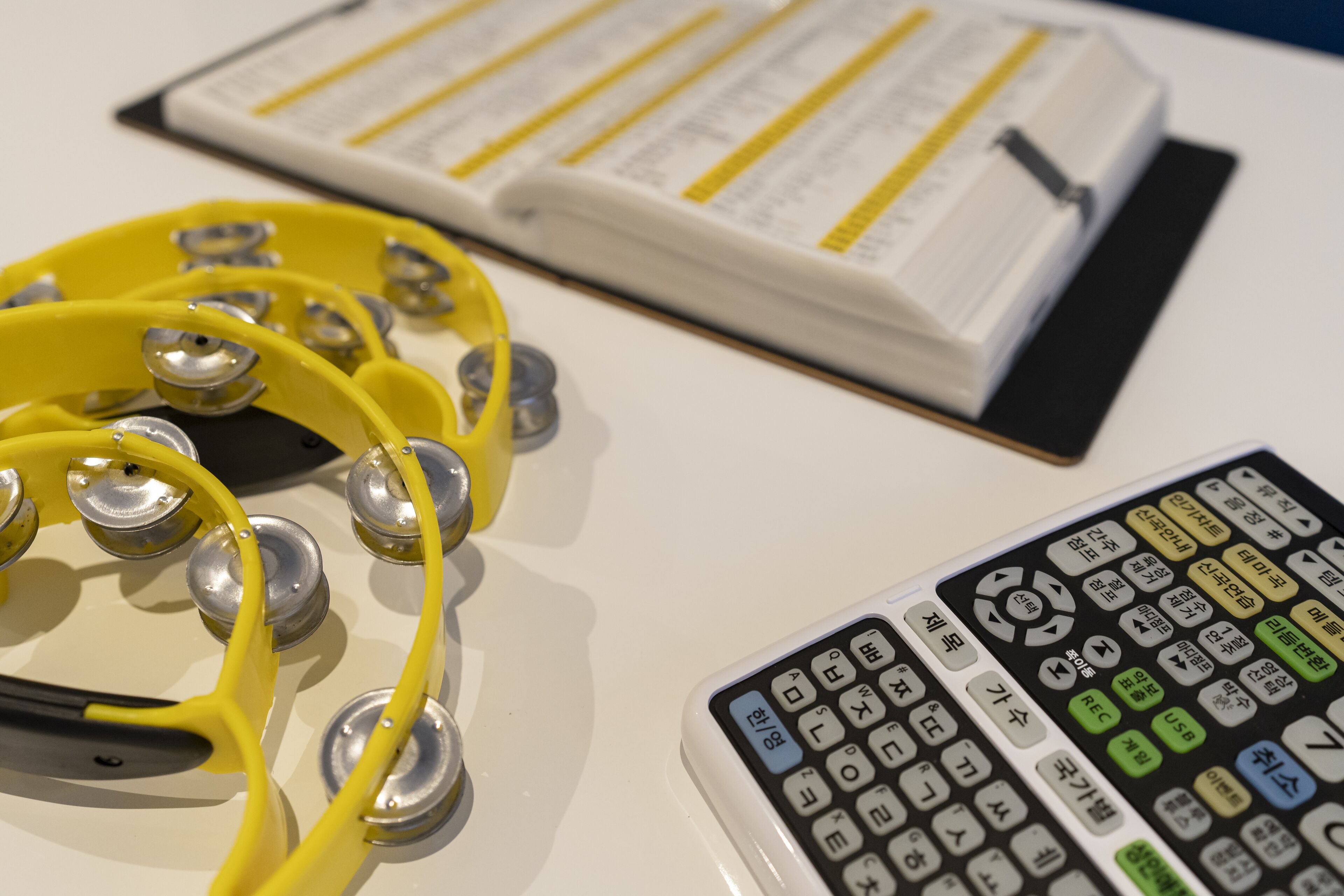 A stethoscope, a calculator, and a book on a table.