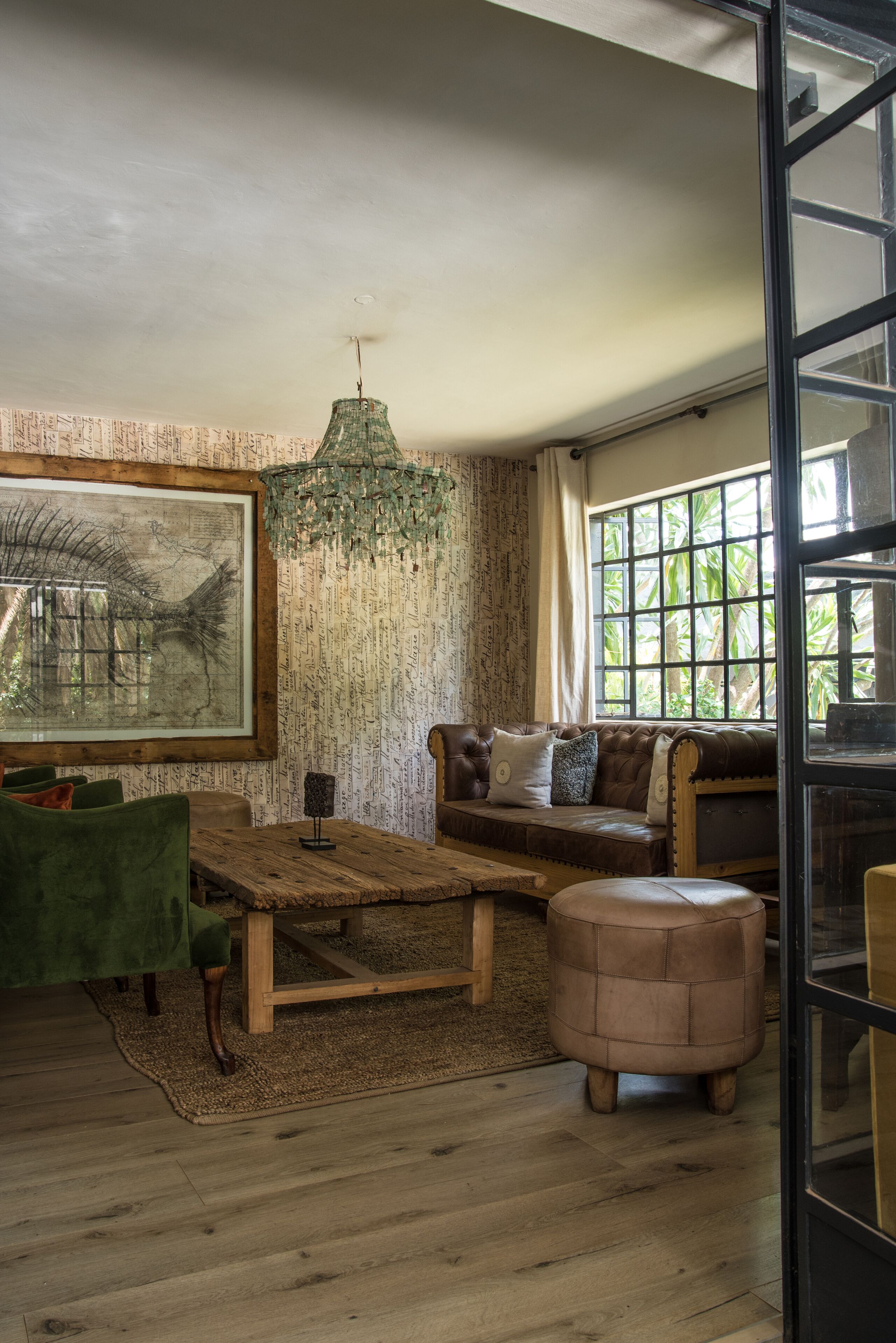 A cozy living room with a wooden coffee table, a green sofa, and a brown leather couch.