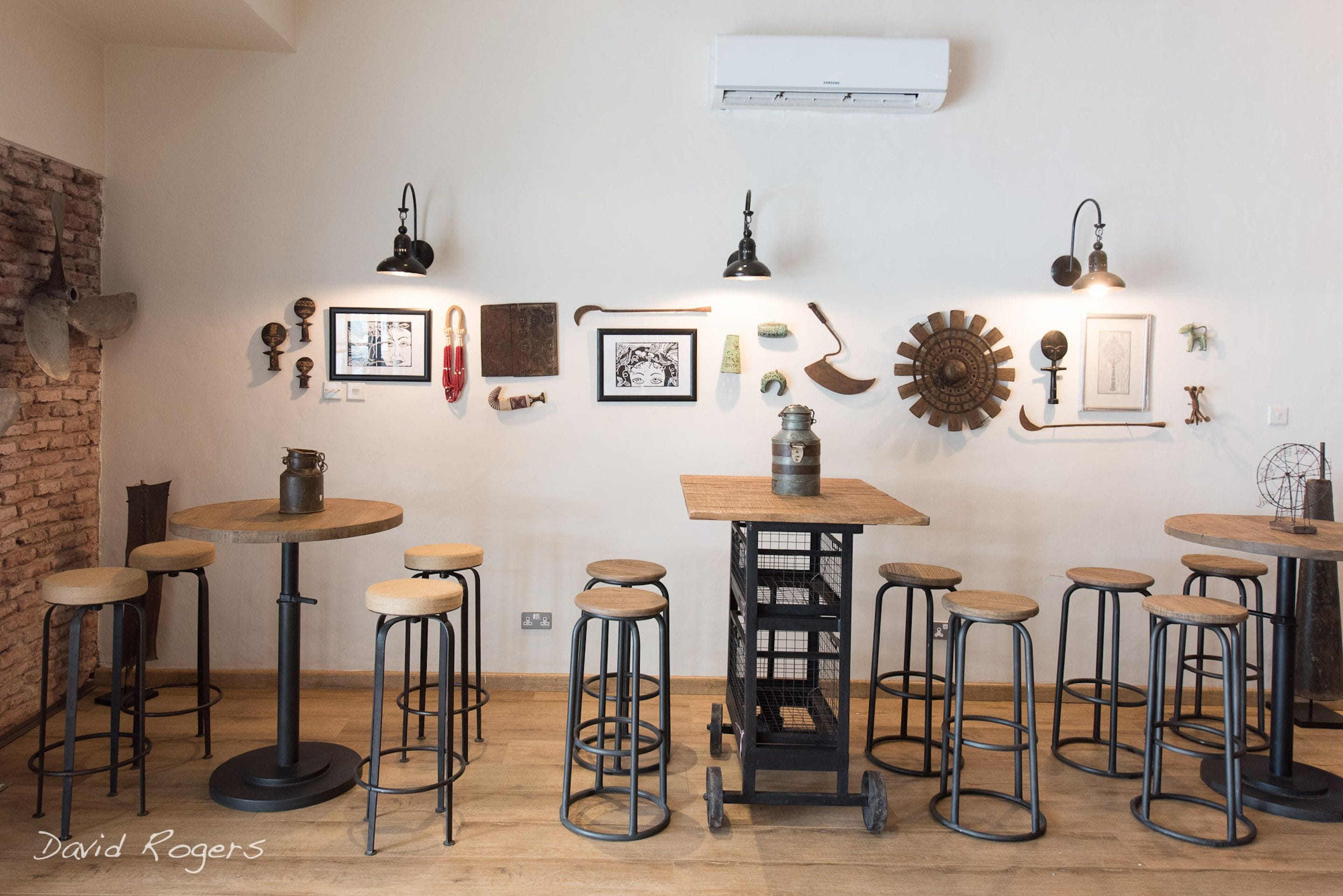 A bar area with stools, tables, and various wall decorations.