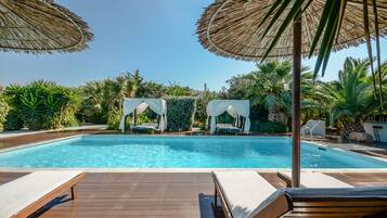 Seasonal outdoor pool, open 8:30 AM to 8:00 PM, pool umbrellas