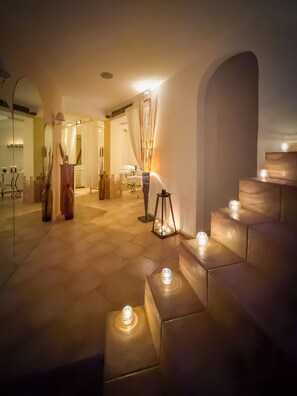 Vestíbulo de hotel con una escalera, una recepción y un área de spa.