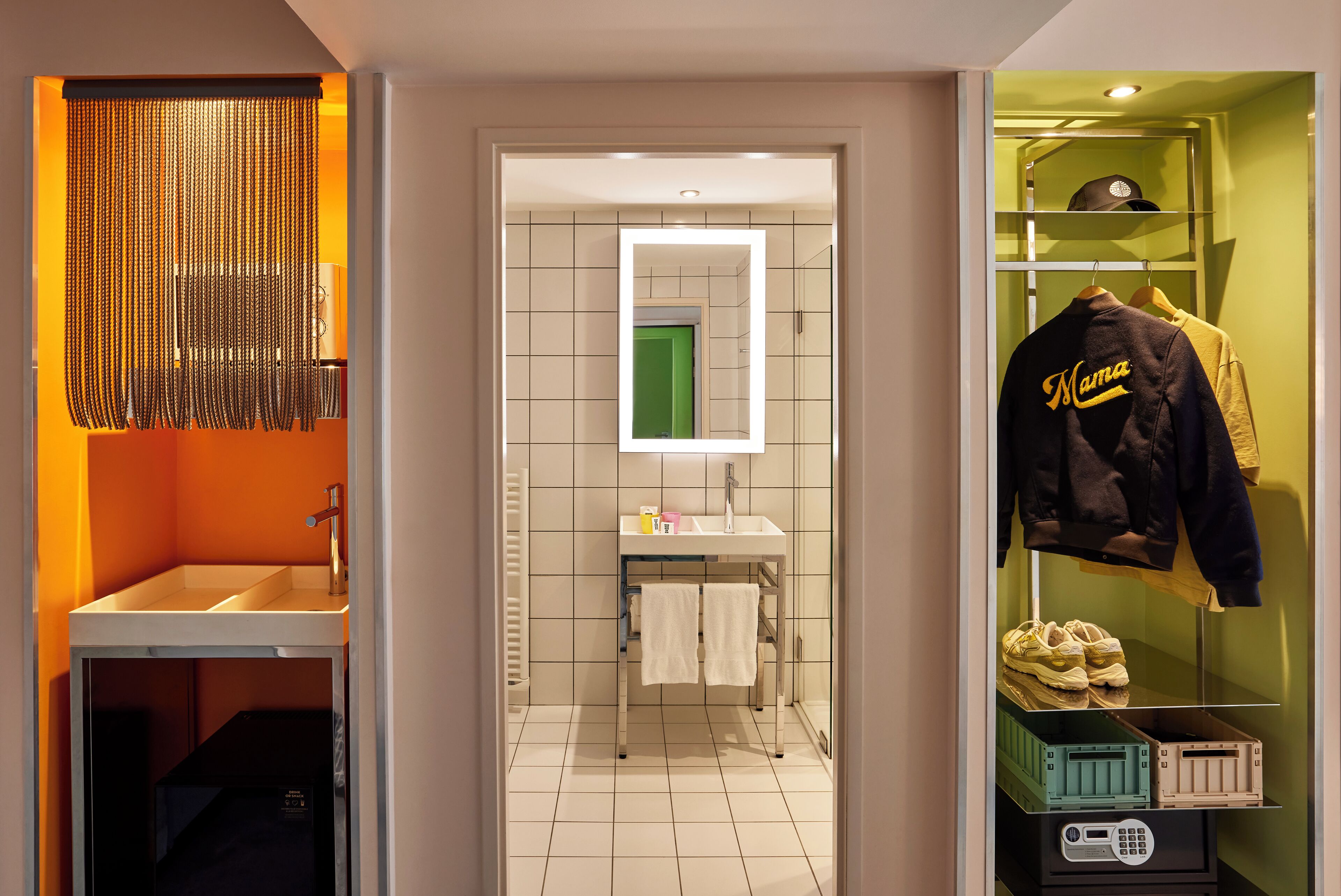 A modern bathroom with a sink, mirror, and towel rack.