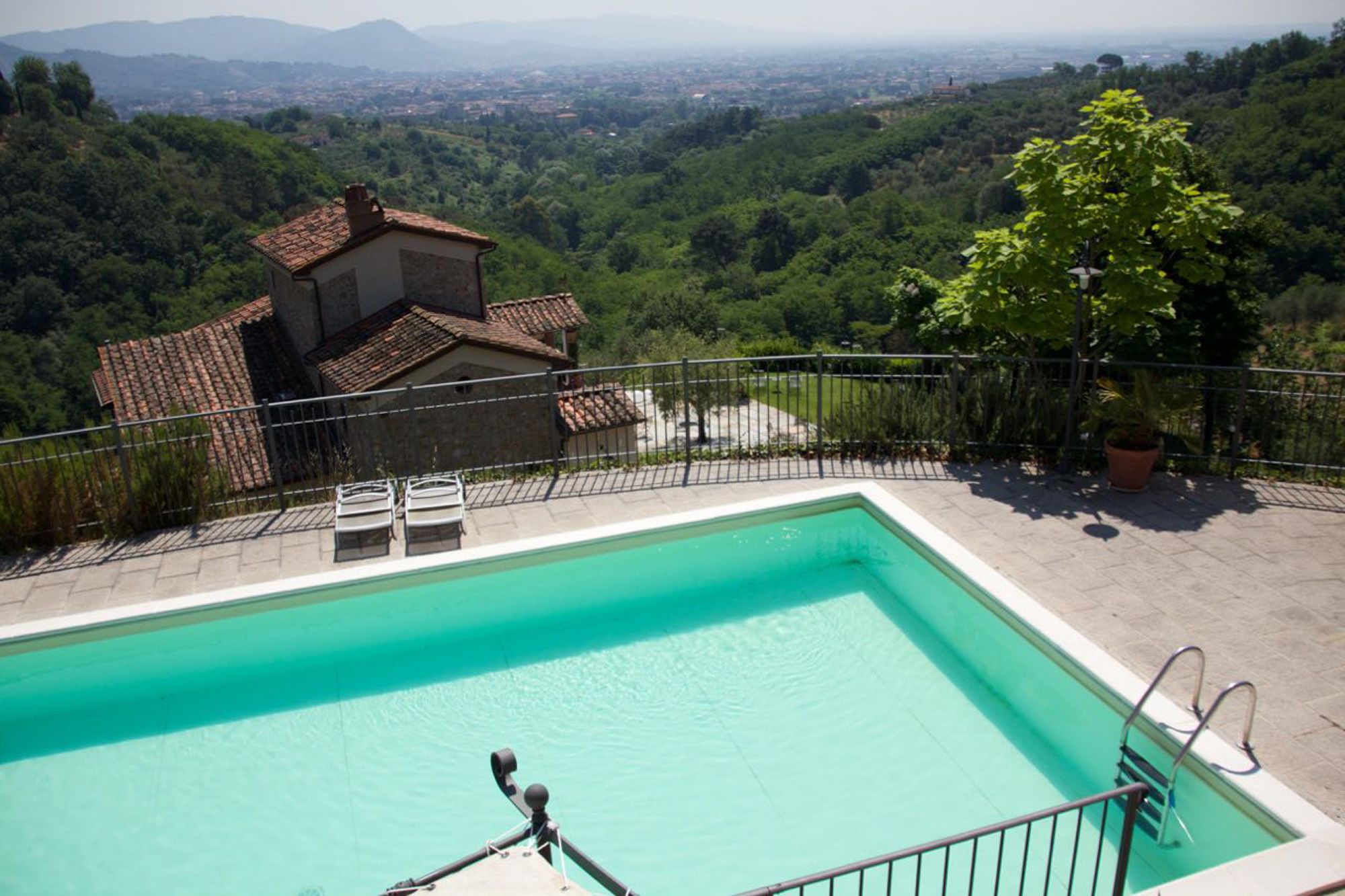 A swimming pool with a view of a mountainous landscape.