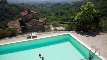 A swimming pool with a view of a mountainous landscape.