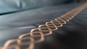 A close-up of a gold chain on a black surface.