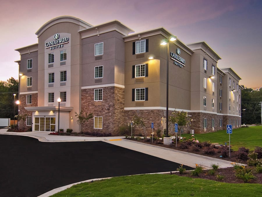 A multi-story hotel with a stone facade and a flat roof.