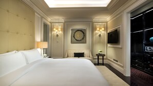 A hotel room with a large bed, a television, a wall-mounted artwork, and a minibar. - Sofitel Legend People's Grand Hotel Xian (Xi'an)