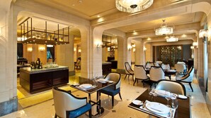 A luxurious dining area with chandeliers, marble flooring, and elegant furniture. - Sofitel Legend People's Grand Hotel Xian (Xi'an)