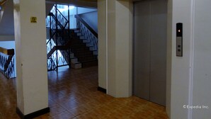 A hallway with a staircase and an elevator. - My Hotel (Davao)