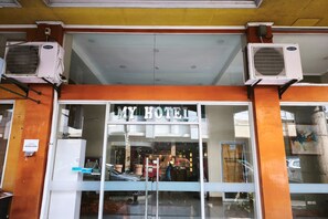 A hotel entrance with a glass facade, air conditioning units above, and a sign reading 'MY HOTEL'. - My Hotel Davao City (Davao)