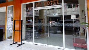 A hotel entrance with a glass door, a sign reading "MI HOTEL", and a "CIRU PACIFIC" sign above the door. - My Hotel (Davao)