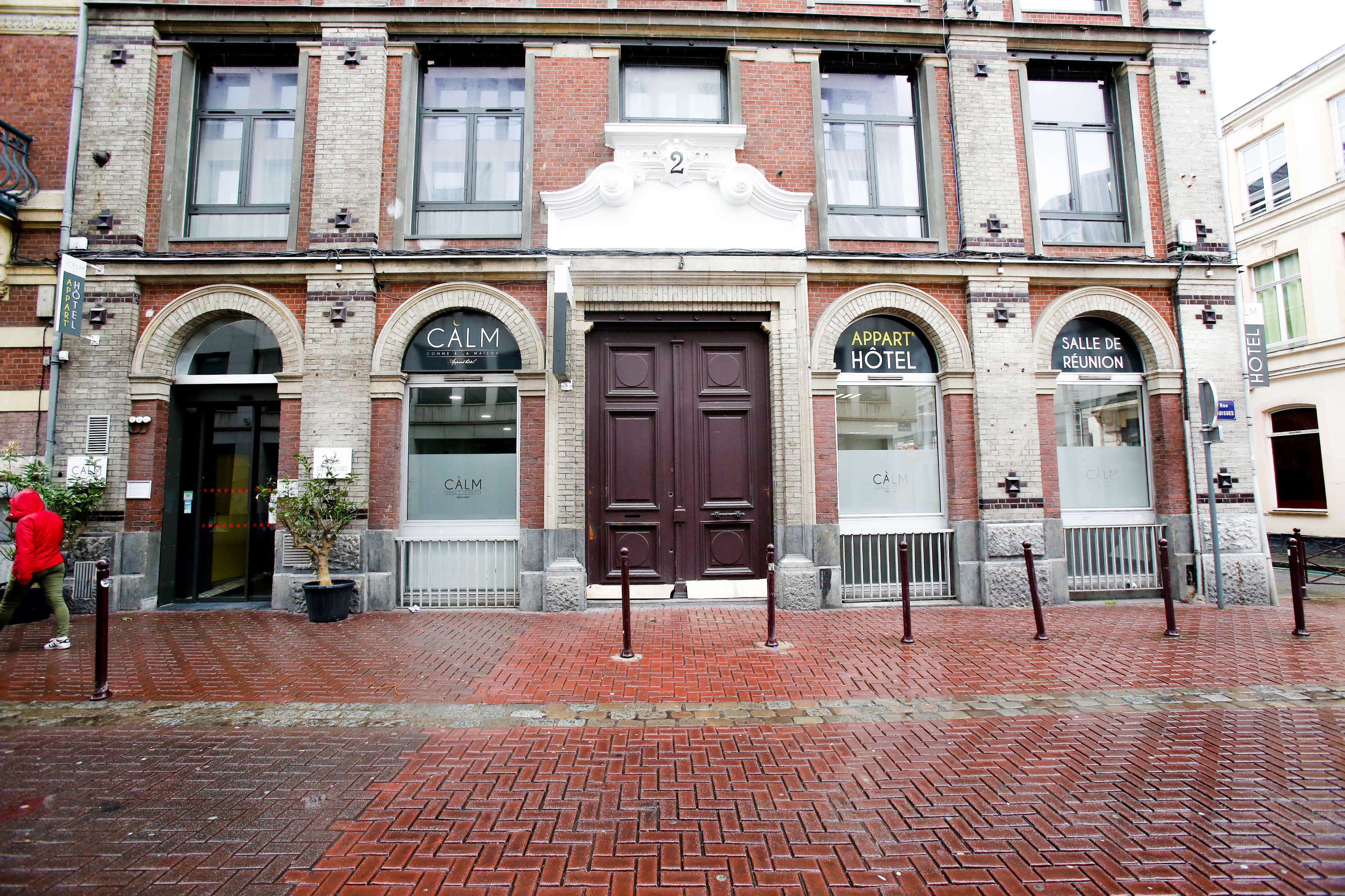 A historic hotel with a prominent entrance, double doors, and arched windows.