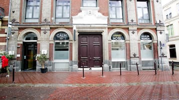 A historic hotel with a prominent entrance, double doors, and arched windows.