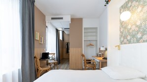 A hotel room with a bed, a desk, two chairs, a wardrobe, and a bathroom visible through an open door. - CALM Appart' & Hostel (Lille)