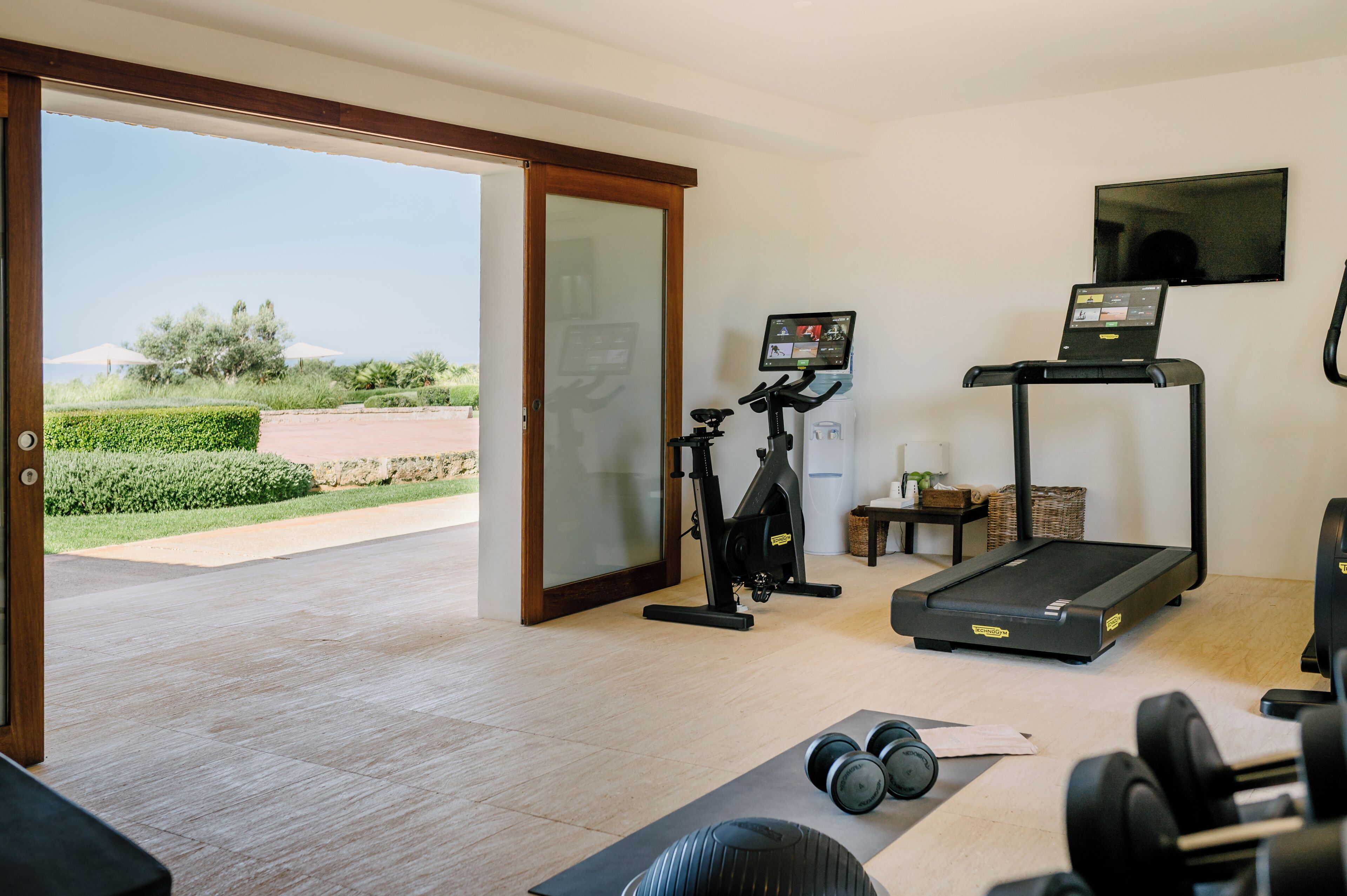A home gym with exercise equipment, a treadmill, and a stationary bike.