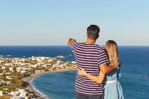A couple overlooking a coastal town with buildings along the shore. - Perigiali Hotel (Skiros)