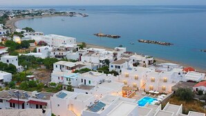 A coastal town with white buildings, a beach, and a clear view of the sea. - Perigiali Hotel (Skiros)