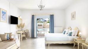 A bedroom with a bed, bedside tables, a desk, a chair, and a television. - Perigiali Hotel (Skiros)