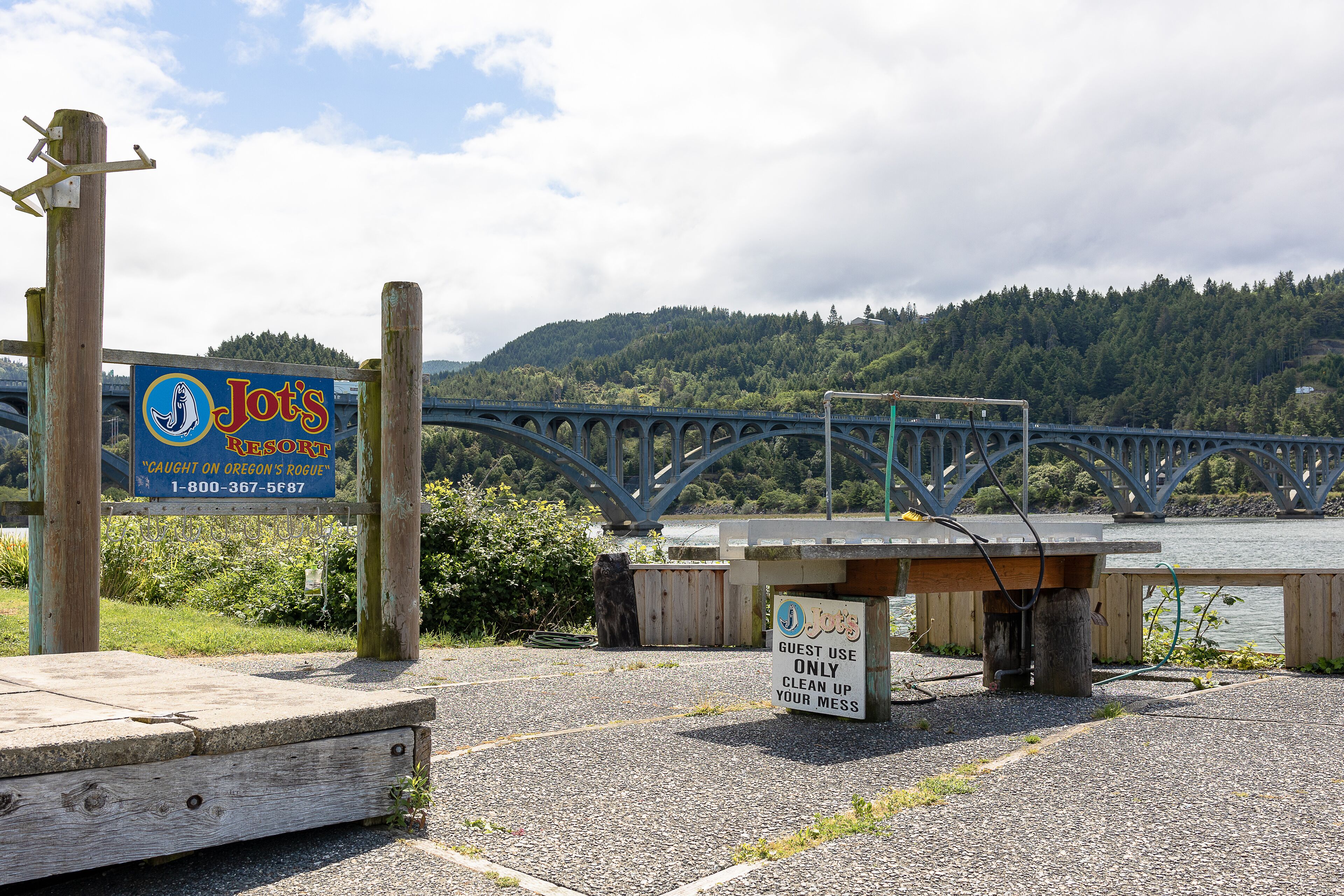 A wooden bench with a sign indicating guest use only and a sign for Jot's Resort.