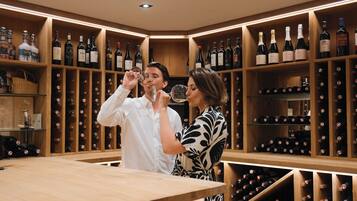 A wine cellar with wooden shelves and bottles.