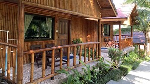 A wooden building with a porch, a door, and a window. - The Fisherman's Chalet (Koh Samui)