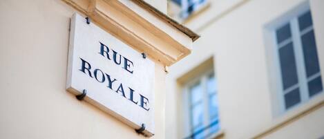 A sign reading "RUE ROYALE" mounted on a building.