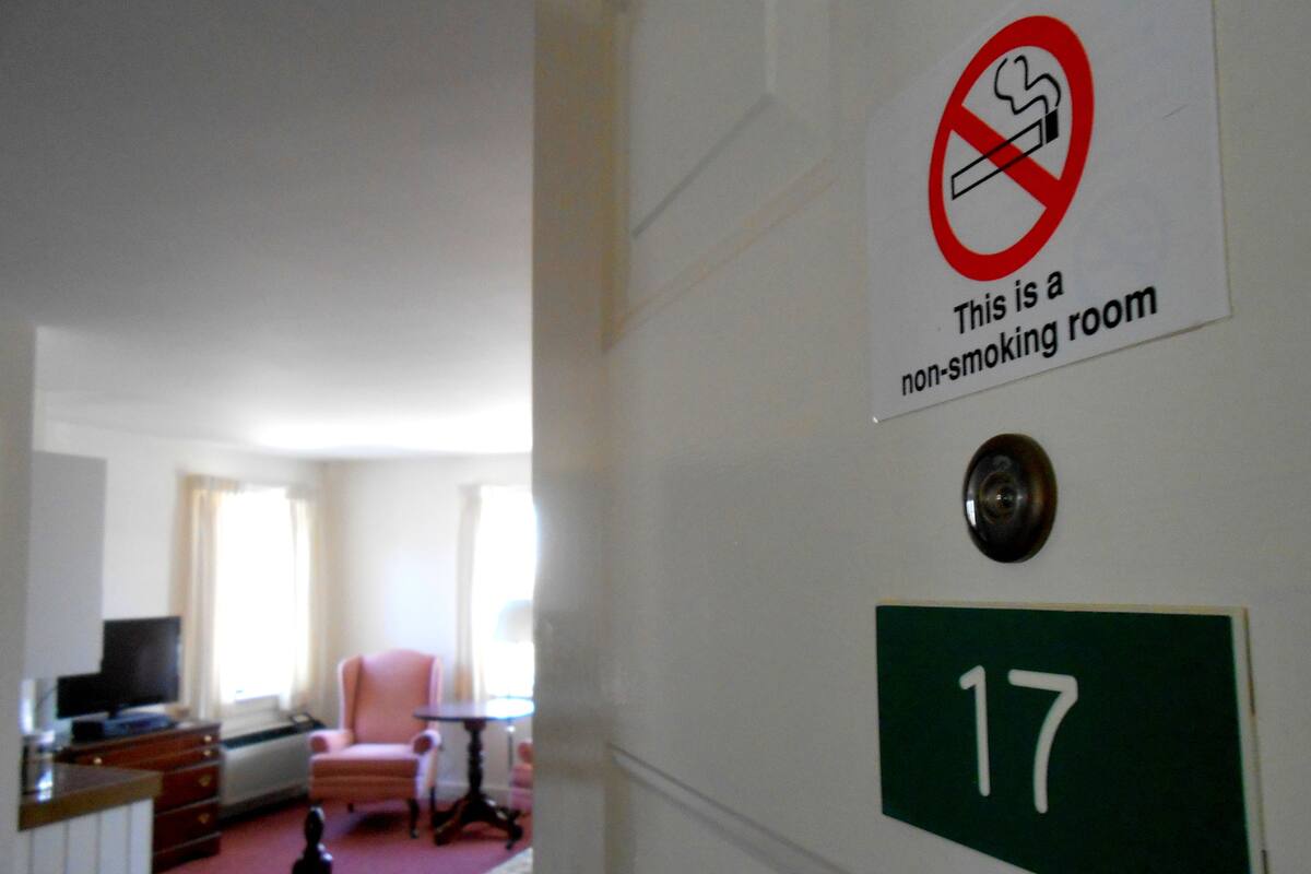 A hotel room with a non-smoking sign and a room number 17.