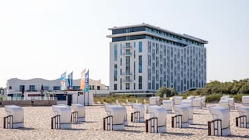 Relax on the beach with lounge chairs and enjoy the hotel's scenic views.