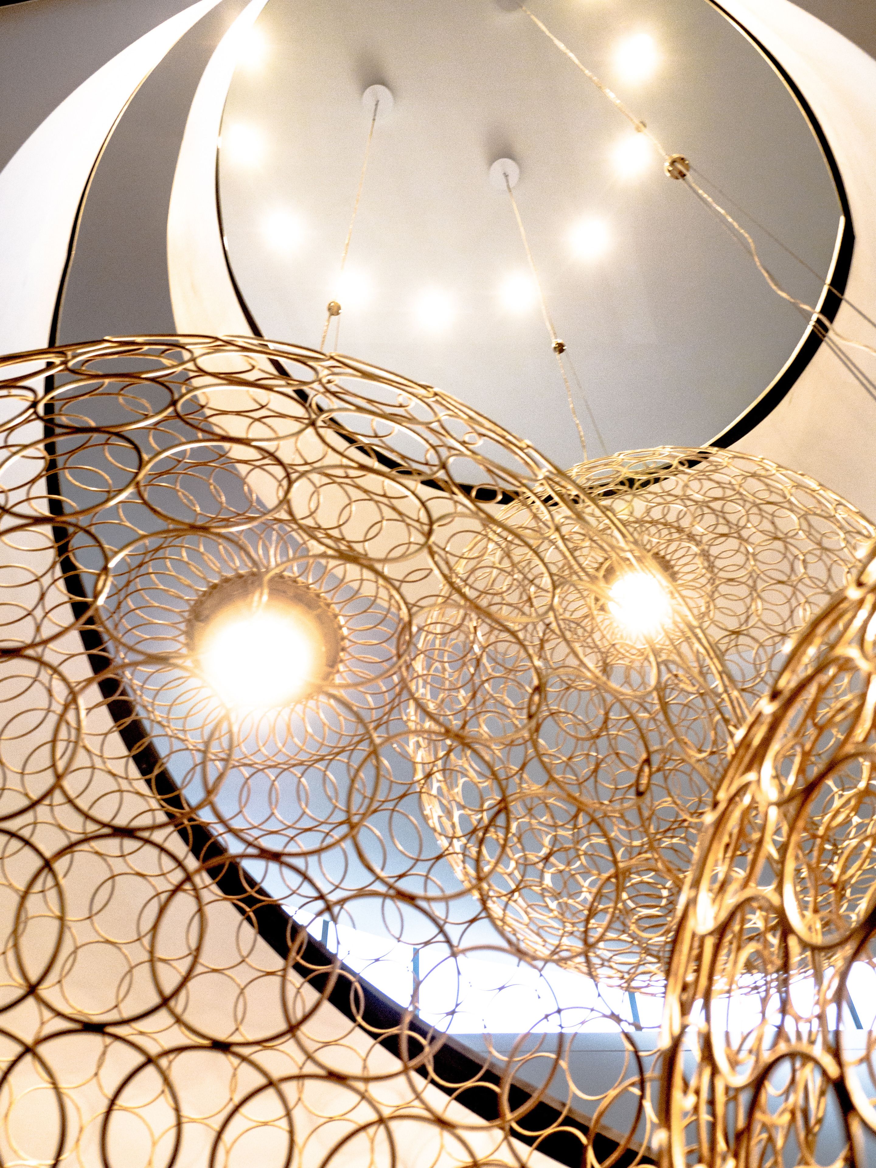 A ceiling with a circular design and multiple light fixtures.