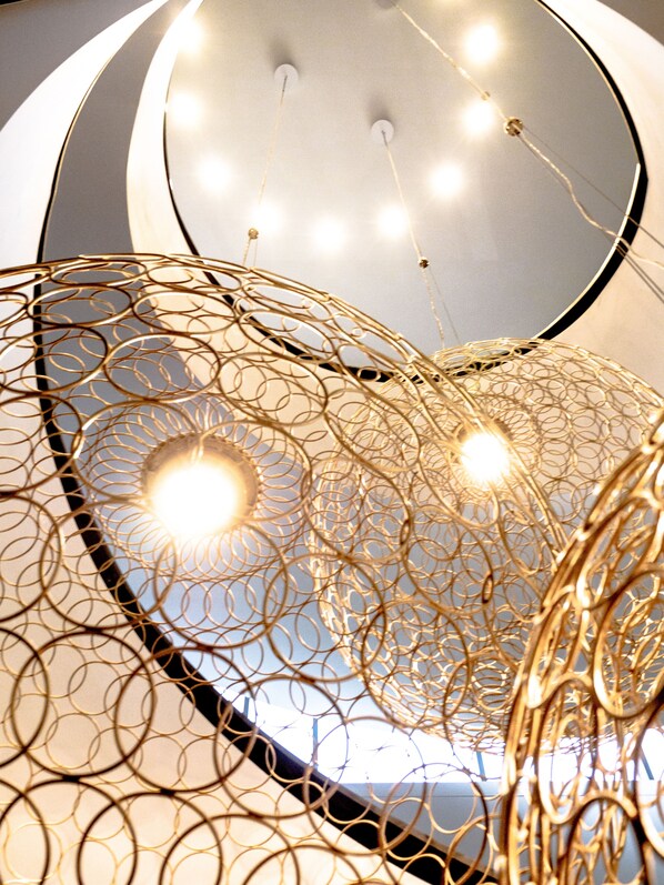 A ceiling with a circular design and multiple light fixtures.