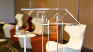 A clear acrylic stand with the text 'Pullman Hotels and Resorts' in the background.