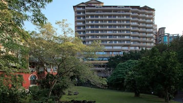 Surrounded by lush greenery, this hotel offers a serene environment with a tranquil water feature and balconies.