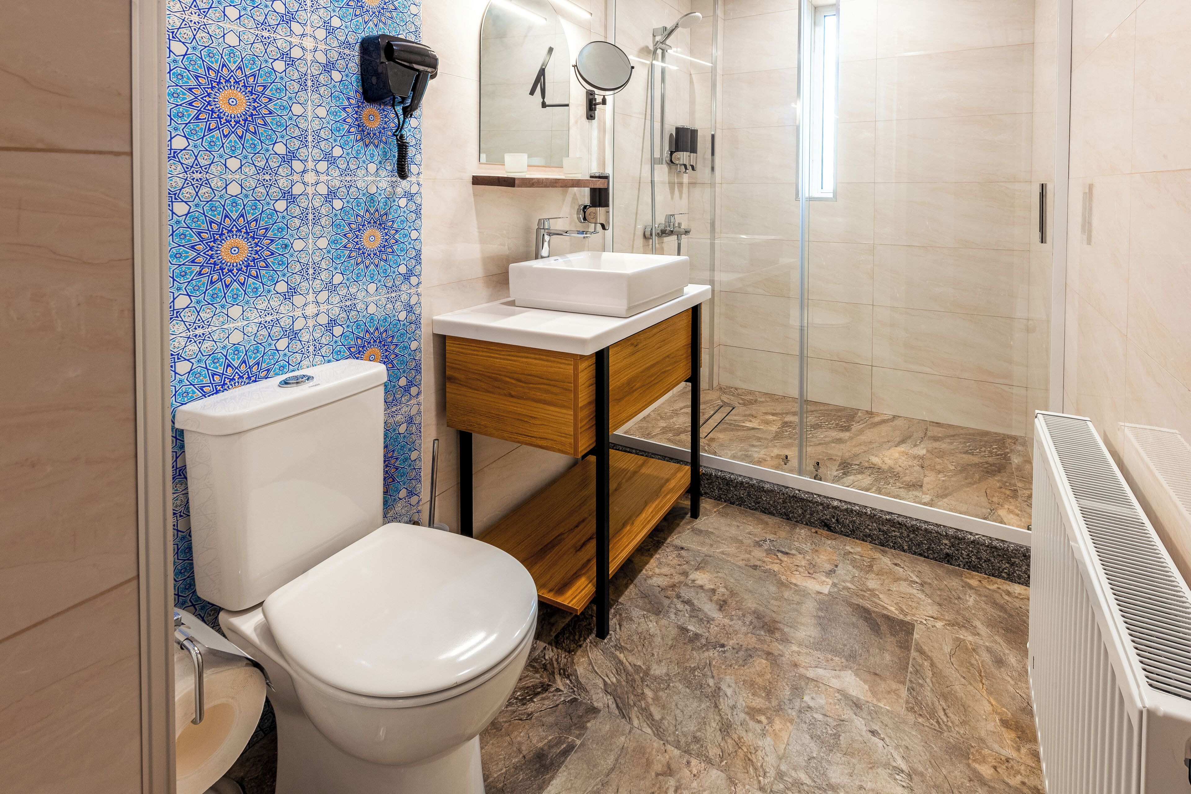 A bathroom with a toilet, sink, and shower.