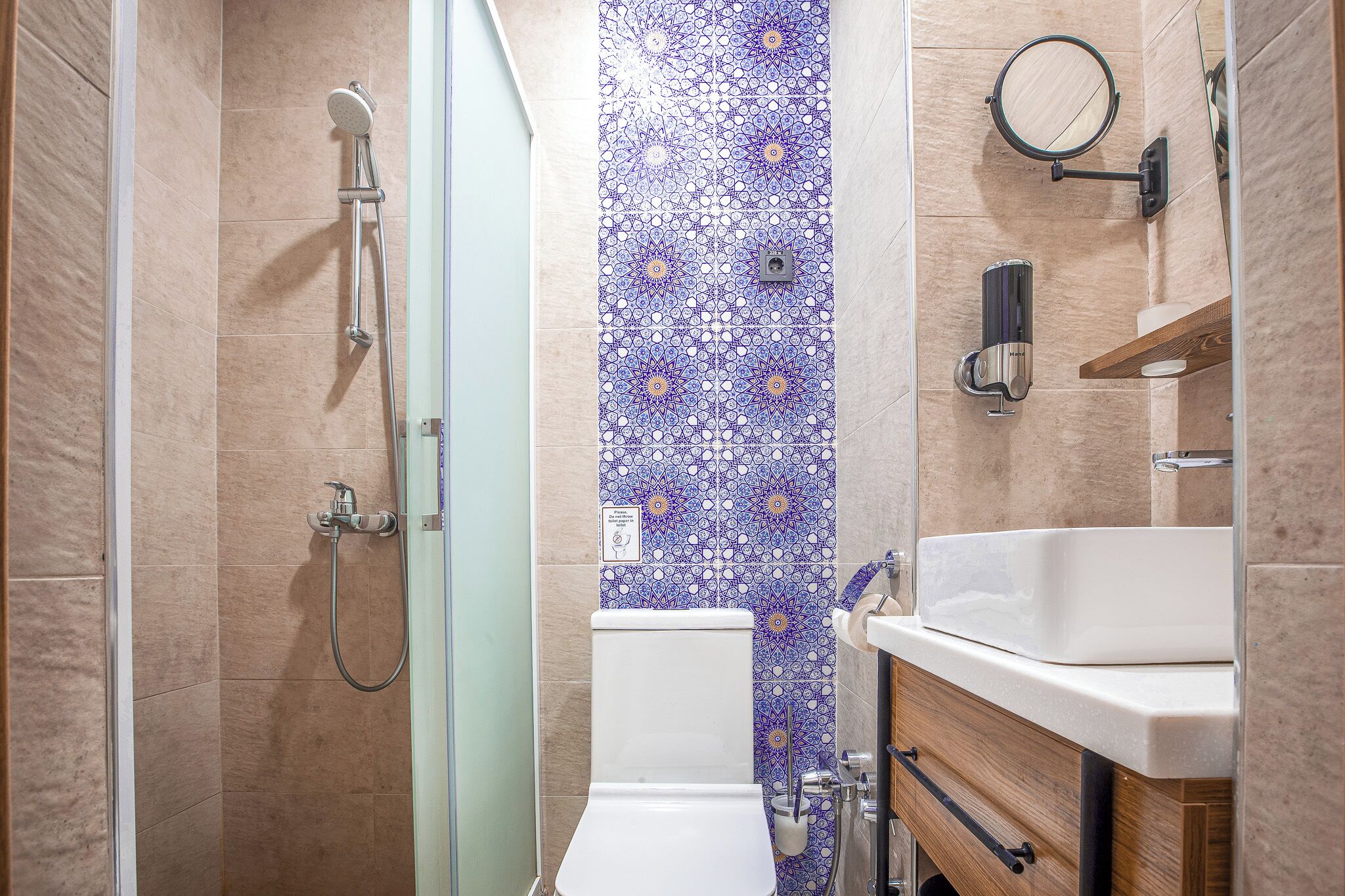 A bathroom with a shower, toilet, and sink.
