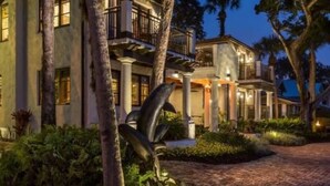 A large, multi-story building with a symmetrical facade, columns, and a covered entrance area. - Black Dolphin Inn (New Smyrna Beach)