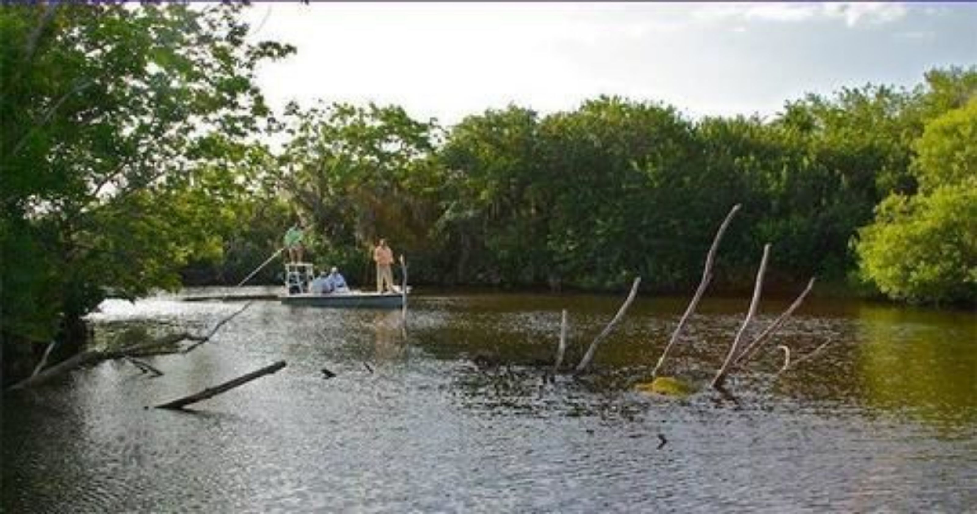 A river with a boat and people on it.