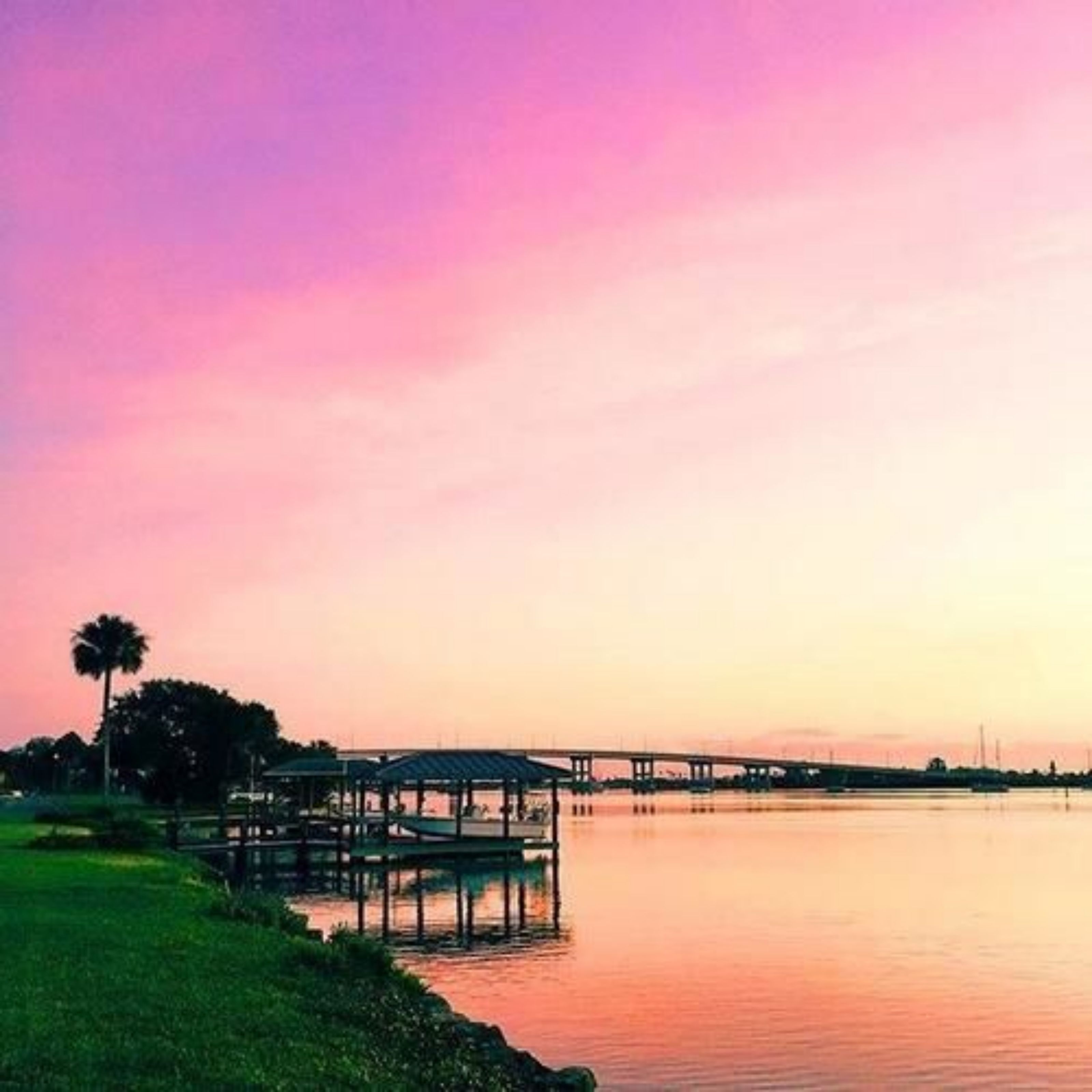 A waterfront view with a pier and a gazebo.