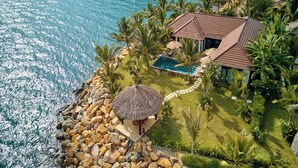 A resort with a swimming pool, a thatched-roof gazebo, and a view of the ocean. - Amiana Resort Nha Trang (Bac Nha Trang)