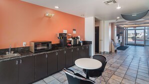 A kitchenette with a microwave, coffee maker, and sink. - Motel 6 Terrell, TX (Terrell)