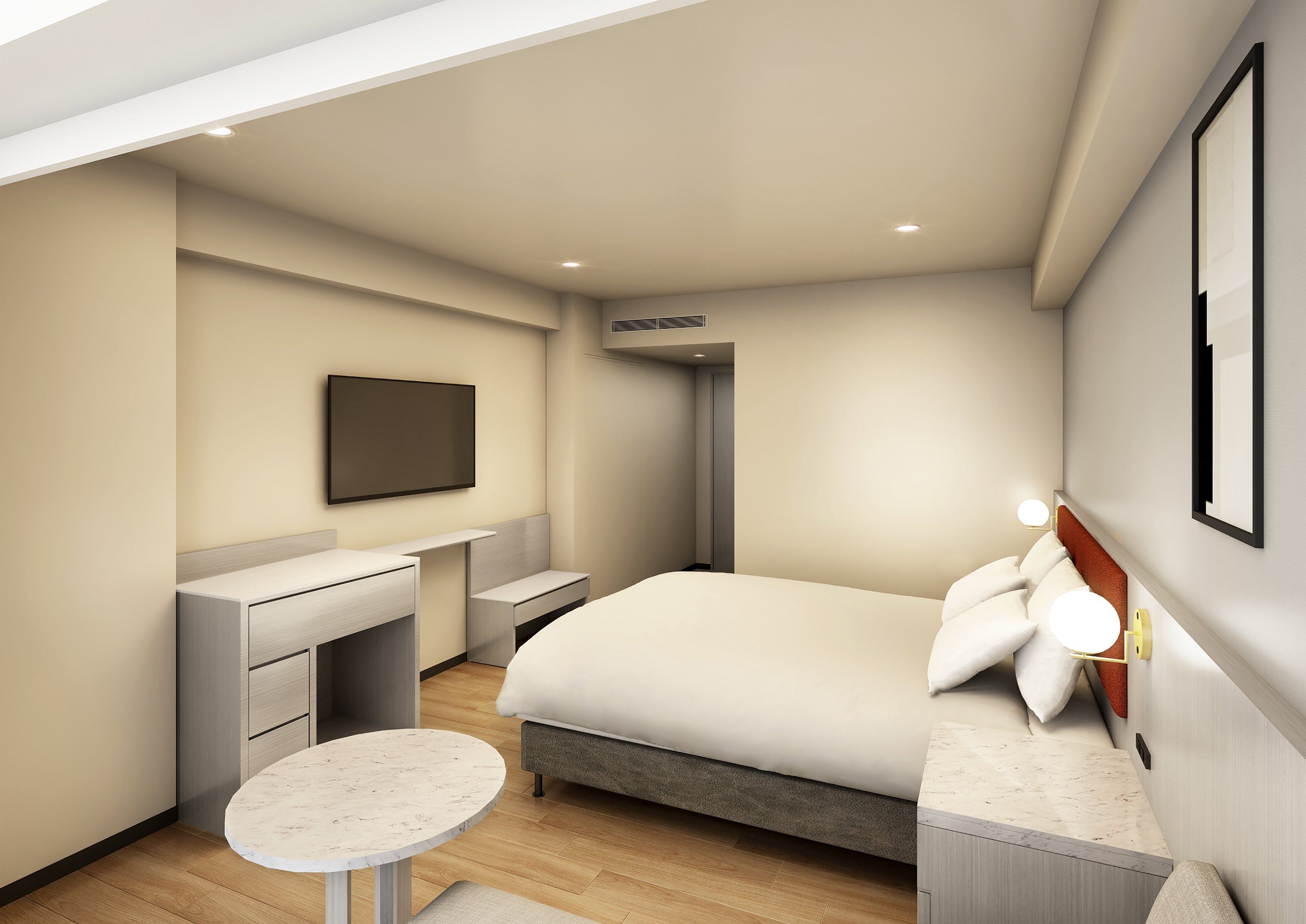 Habitació d'hotel moderna amb llit, taula de nit, una taula rodona petita, escriptori, cadira, televisió de pantalla plana i aire condicionat fixat a la paret.