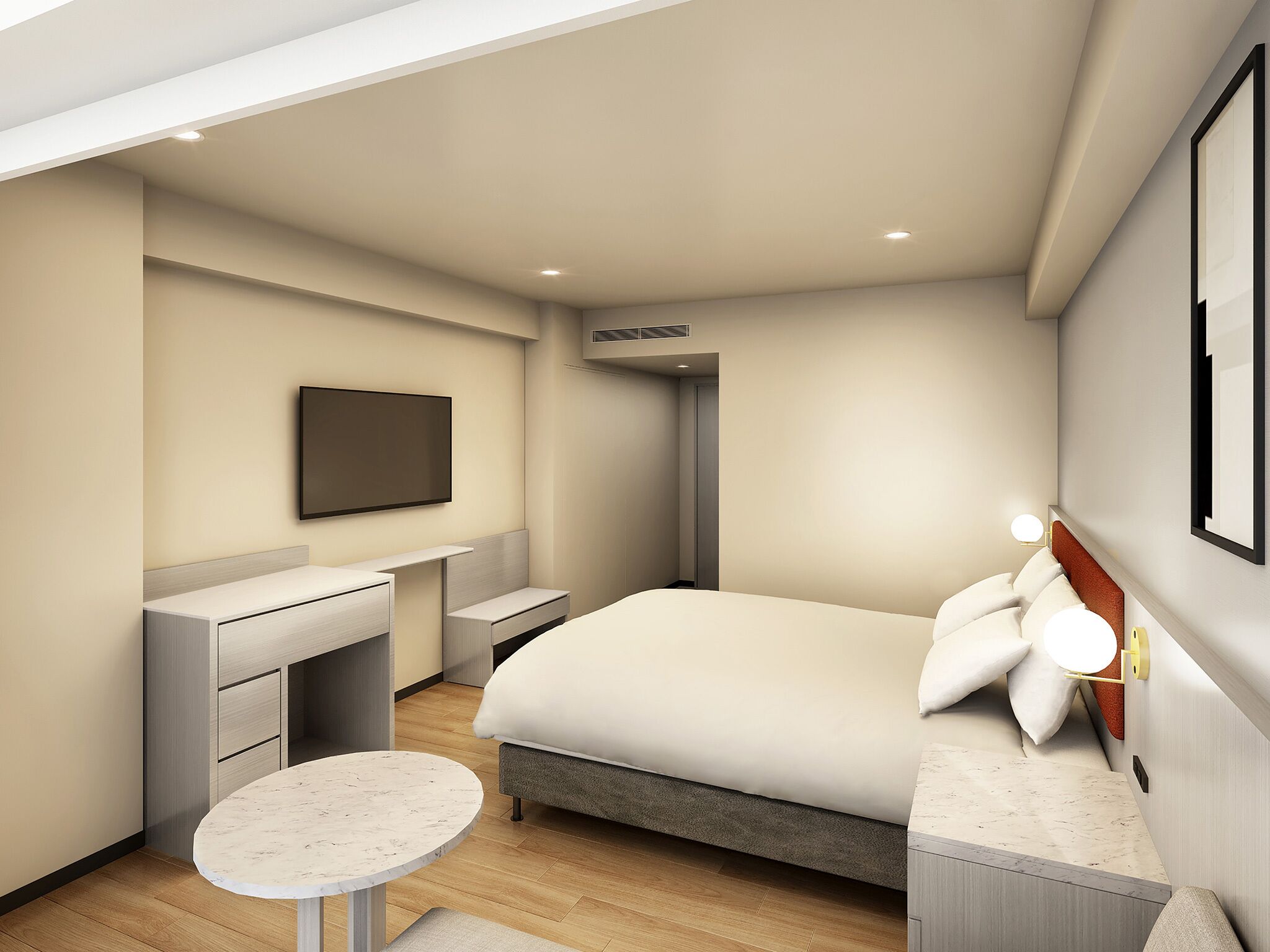 A modern hotel room with a bed, a desk, a chair, a small table, a TV, and a wall-mounted light.