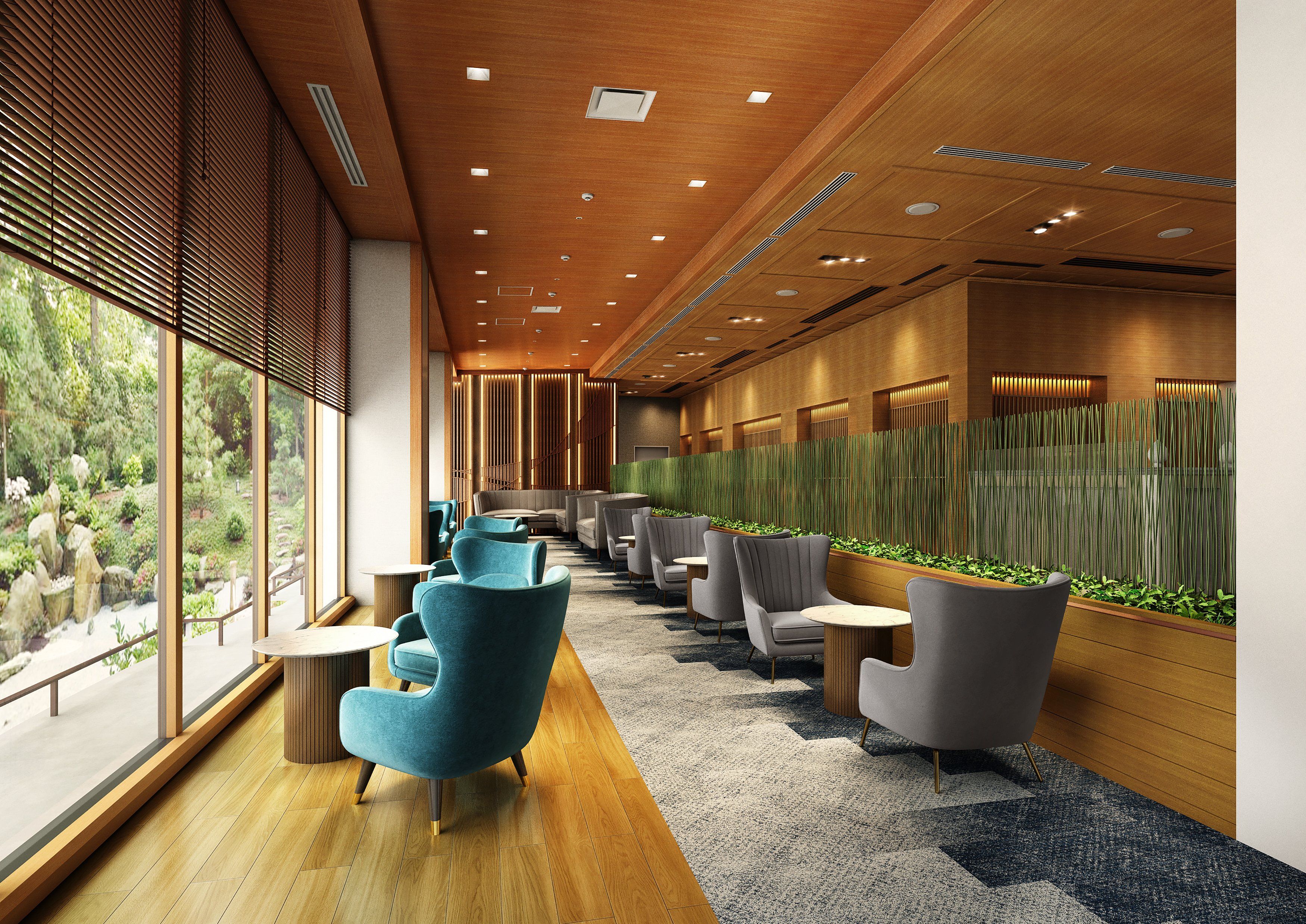 A modern interior with a long corridor, seating area, and a view of greenery outside.